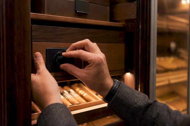 Hands adjusting humidor controller dial